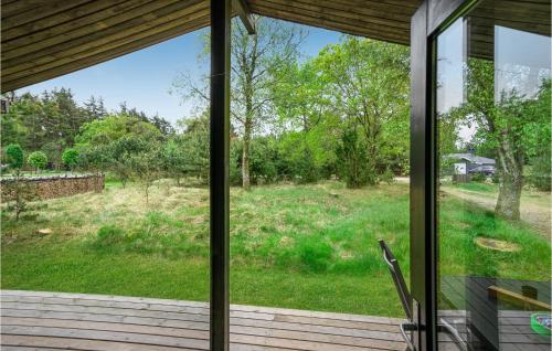 a view of a yard from a screened porch at Brincken in Vejers Strand