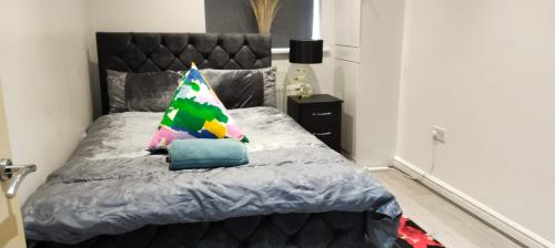a bedroom with a bed with a pillow on it at 38 Church Street Luxury Flat in Warrington