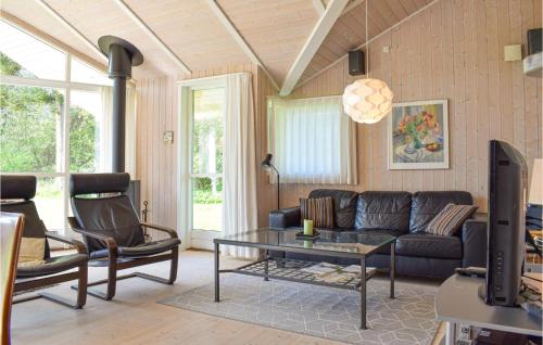 a living room with a couch and a table at Holiday Home Lerager in Gilleleje