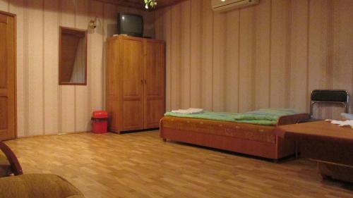 a room with a bed and a wooden floor at Zajazd U Renaty in Poraj