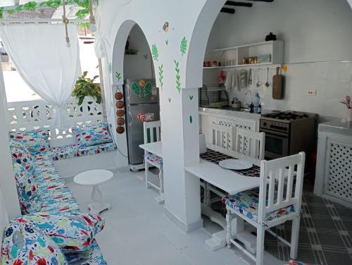a kitchen with a table and chairs in a room at Nyumba Tulivu in Watamu