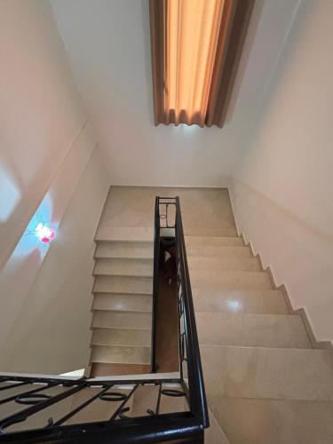 a staircase in a room with a stair railing at Hekma by El kateb in Fafou