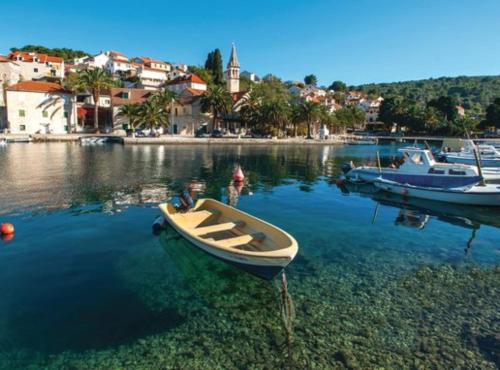 a small boat in the water in a harbor at Holiday Home Aurora in Splitska