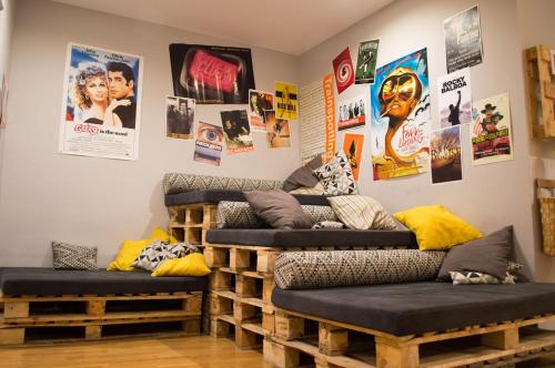 a room with two couches and posters on the wall at Onefam Sungate in Madrid