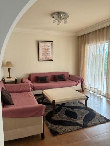 a living room with a couch and a table at Hekma by El kateb in Fafou