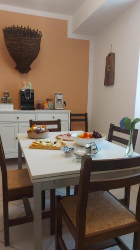 a kitchen with a table with some food on it at Borgo Paradiso Guest House in Maccagno Inferiore