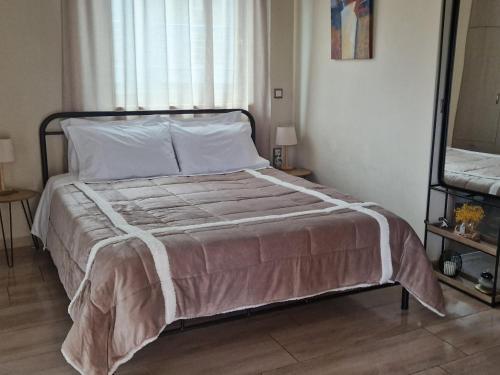 a bed in a bedroom with a large window at Olivia in Chania Town