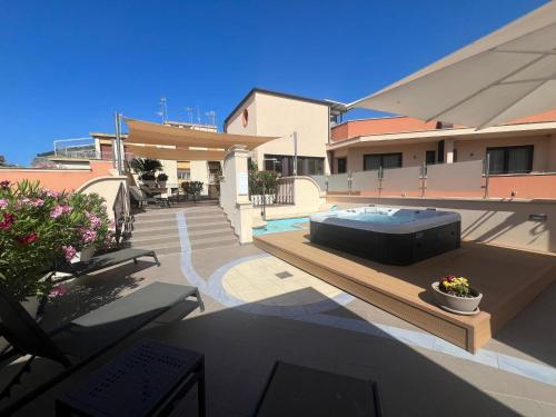 a house with a bed on top of a patio at Artemis Hotel in Cefalù