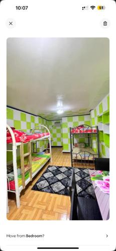 a room with two bunk beds in a room at Deyo Guest House Room Green in Butuan