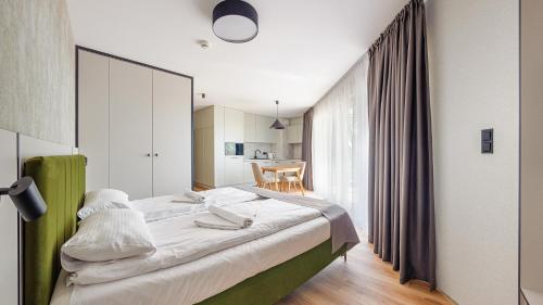 a bedroom with a large bed in a room at Apartamenty Helski Brzeg in Hel