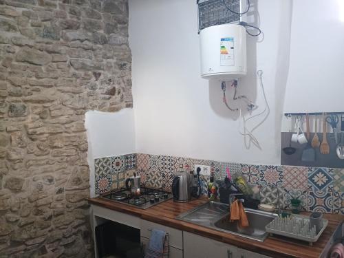 a kitchen with a sink and a stove top oven at High Flyers Kite House in Tarifa