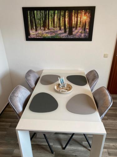 a white table with a ring on top of it at Ferienwohnung Plaue Auszeit mit Privatstrand und Bootsliegeplatz in Zislow