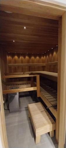 a wooden cabinet with two wooden benches in a room at Kauppahotelli in Lahti