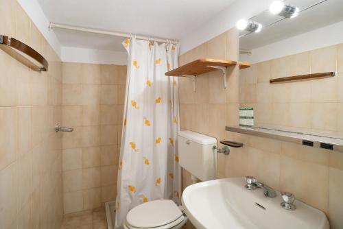 a bathroom with a toilet and a sink at Monolocale con soppalco 43 in Albenga