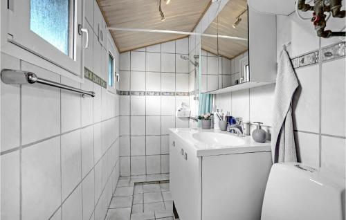 a white bathroom with a sink and a tub at 3 Bedroom Lovely Home In Karrebæksminde in Karrebæksminde