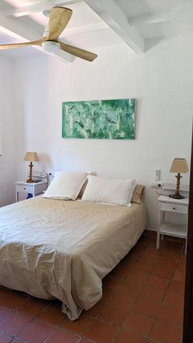 a bedroom with a large bed with two night stands at Vinya Alice in Ciutadella