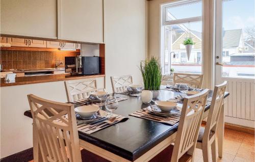 a kitchen with a table with chairs and a dining room at Amazing Home In Karlsborg With Wifi in Karlsborg
