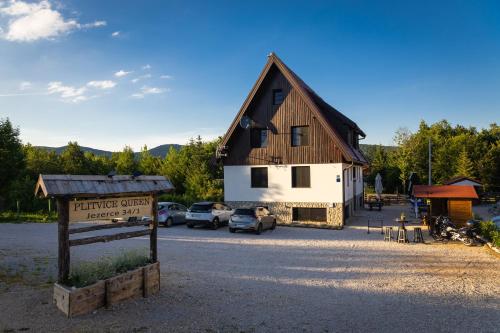 a building with a sign in front of a parking lot at B&B Plitvice Queen in Plitvička Jezera
