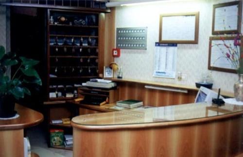 a bar with a glass counter in a pharmacy at Hotel Capri in Pasian di Prato