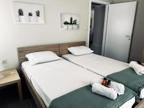 two beds in a room with plants on the wall at lifeguard beachfront - Luxury Flat, 30meters From Sea in Stalos