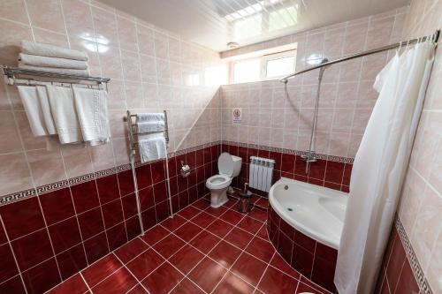 a bathroom with a toilet and a sink at Qibla Tozabog in Khiva