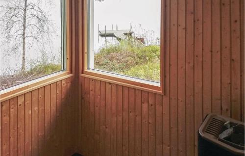 a room with two windows and a trash can at Lovely Home In Skånes Fagerhult in Skånes Värsjö