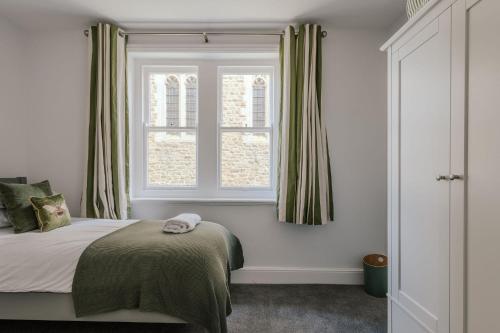 a bedroom with a bed and a window at The Lynton Lookout in Margate