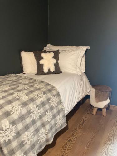 a bed with white pillows and a blanket at Grande Cote Room and Breakfast in Cesana Torinese