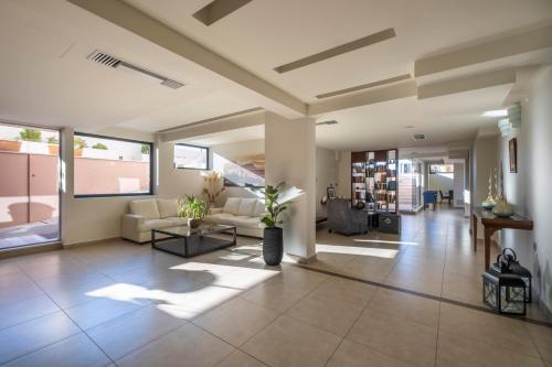 a living room with a couch and a table at Harmony Hotel Nafplio in Nafplio