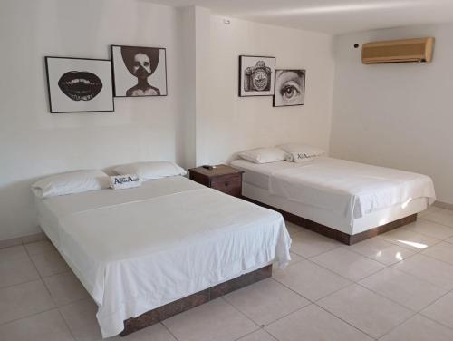 Postel nebo postele na pokoji v ubytování Hotel Agua Azul Melgar Tolima