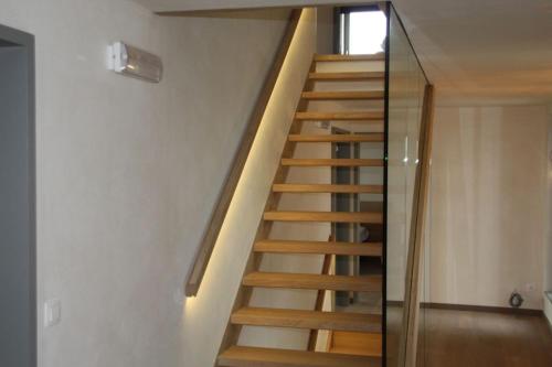 a wooden staircase in a room with a window at luxe vakantiehuis met panoramisch uitzicht Nisramont in La Roche-en-Ardenne