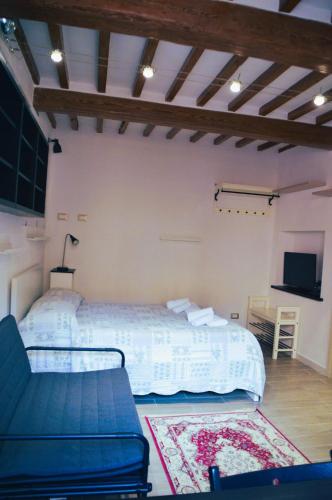 a bedroom with a bed and a tv and a couch at antignano mare in Livorno