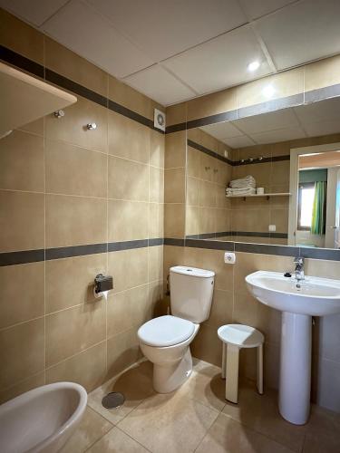 a bathroom with a toilet and a sink at Esmeralda Suites Calpe in Calpe