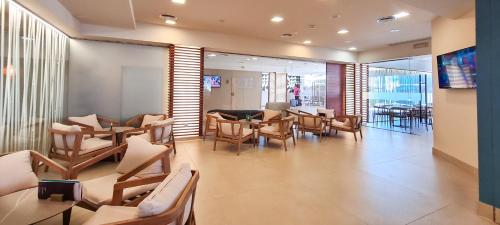 a restaurant with chairs and tables in a room at Hotel Cesar Augustus in Cambrils