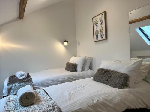 two beds in a room with white walls at Newcastle City Centre Loft Gem in Newcastle upon Tyne