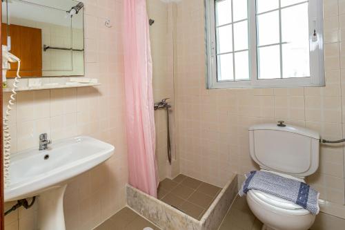 a bathroom with a toilet and a sink and a shower at Melissa Gold Coast in Psakoudia
