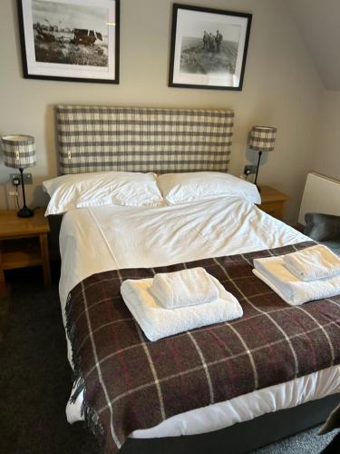 a bedroom with a bed with two towels on it at The Shore in Kirkwall