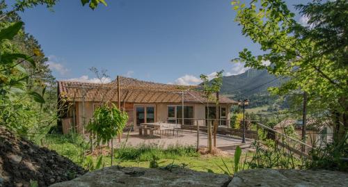 a house with a table and a fence in front of it at Au son du Diois - Gîte de groupe et familial - Die in Die