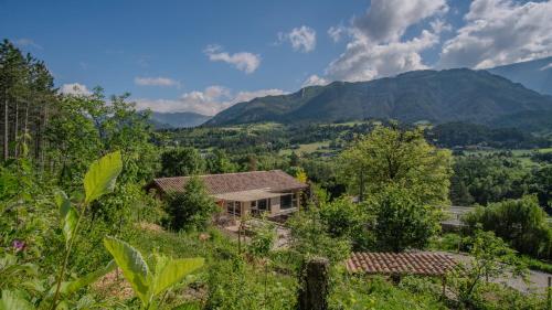 an image of a house with mountains in the background at Au son du Diois - Gîte de groupe et familial - Die in Die