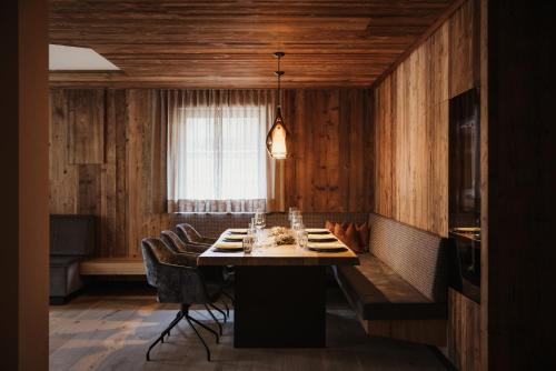 a dining room with a table and chairs and a window at Luxury Chalet Milé in Ortisei