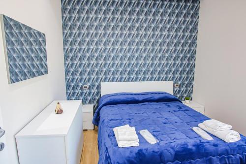 a bedroom with a bed with a blue comforter at Villa Teresa Relax in Corbara