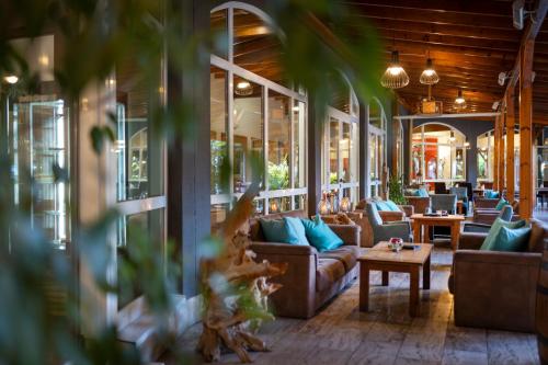 a living room with couches and a table at Rogner Hotel Tirana in Tirana