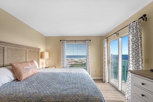 a bedroom with a bed and a large window at 6512 Gulf Shores Plantation-Palms in Gulf Shores