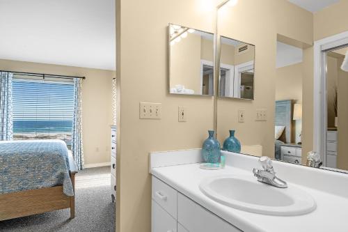 a bathroom with a sink and a mirror at 6512 Gulf Shores Plantation-Palms in Gulf Shores