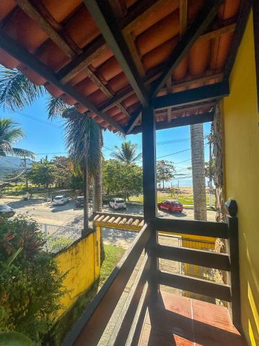 a balcony with a view of the beach at Pousada Sol Nascente in Paraty