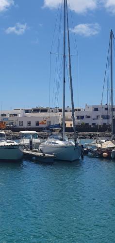 a group of boats docked at a marina in the water at Velero Puma 32 in Caleta de Sebo