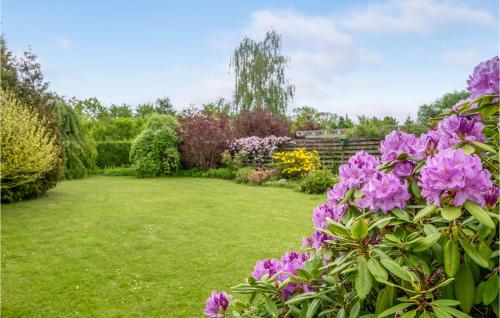 a garden with purple flowers in a yard at Awesome Home In Jægerspris With Kitchen in Jægerspris