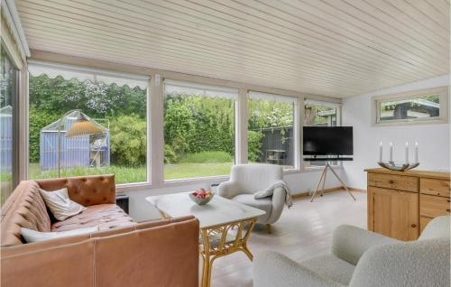 a living room with a couch and chairs and a tv at Awesome Home In Jægerspris With Kitchen in Jægerspris