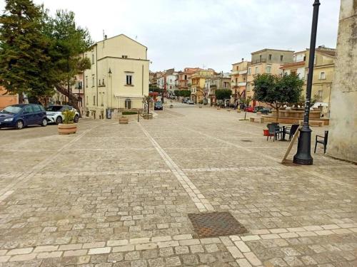 an empty street in a city with buildings at Amazing Gargano in Ischitella