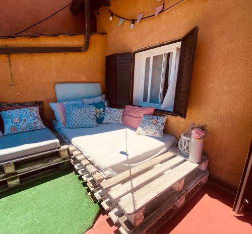 a bed in a room with a window at CASA LAS HERRERA in Casavieja